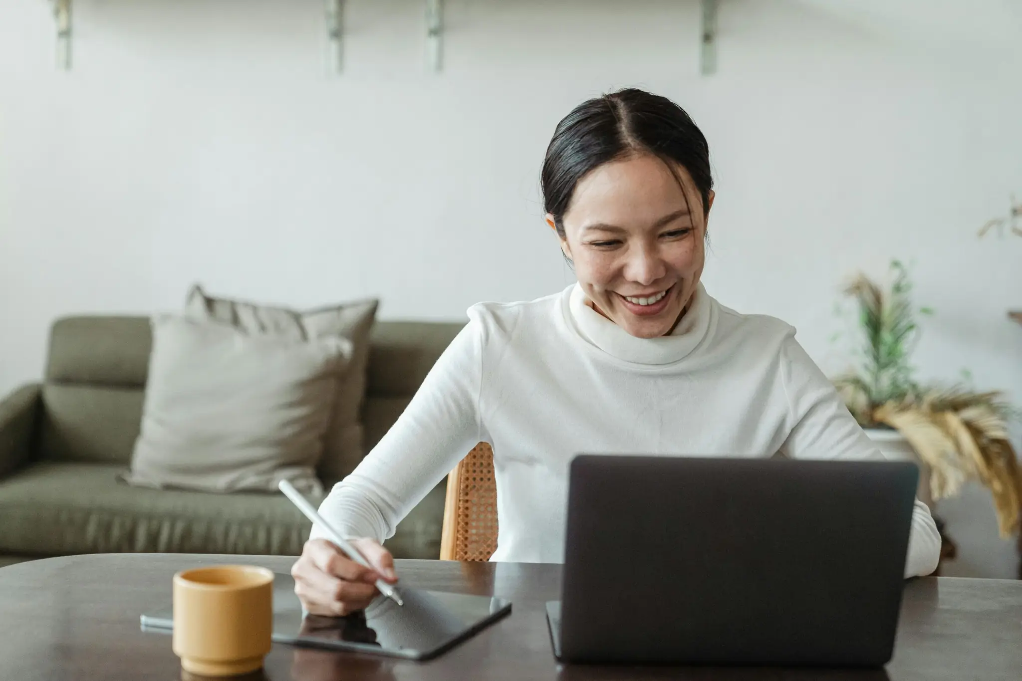 Surrogacy coordinator reviewing agency work from a laptop